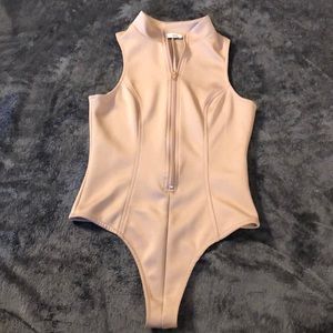 SMALL nude Zip up body suit from Fashion Nova